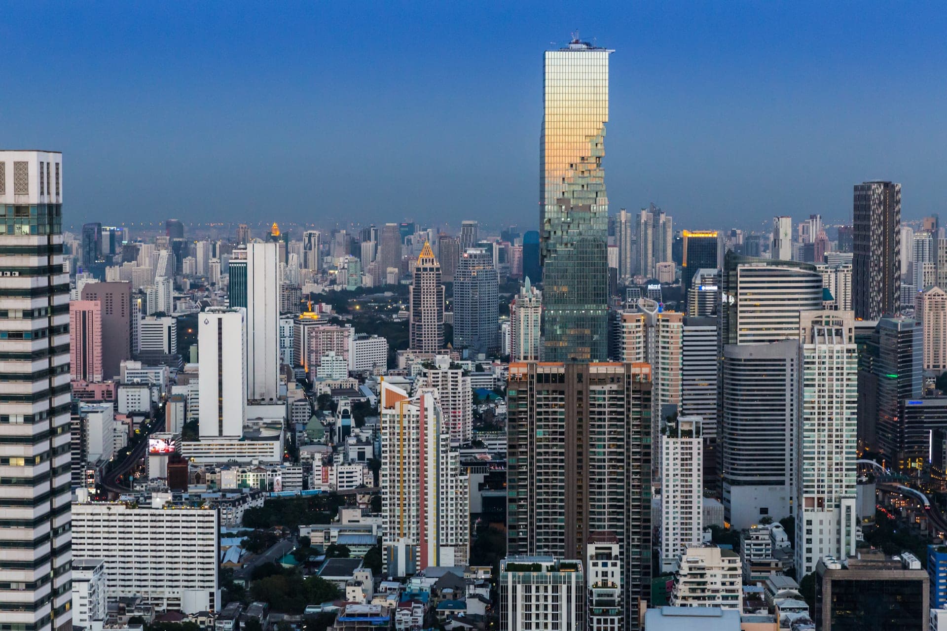 Bangkok's skyline of glass towers, the pixelated MahaNakhon tower standing out among them