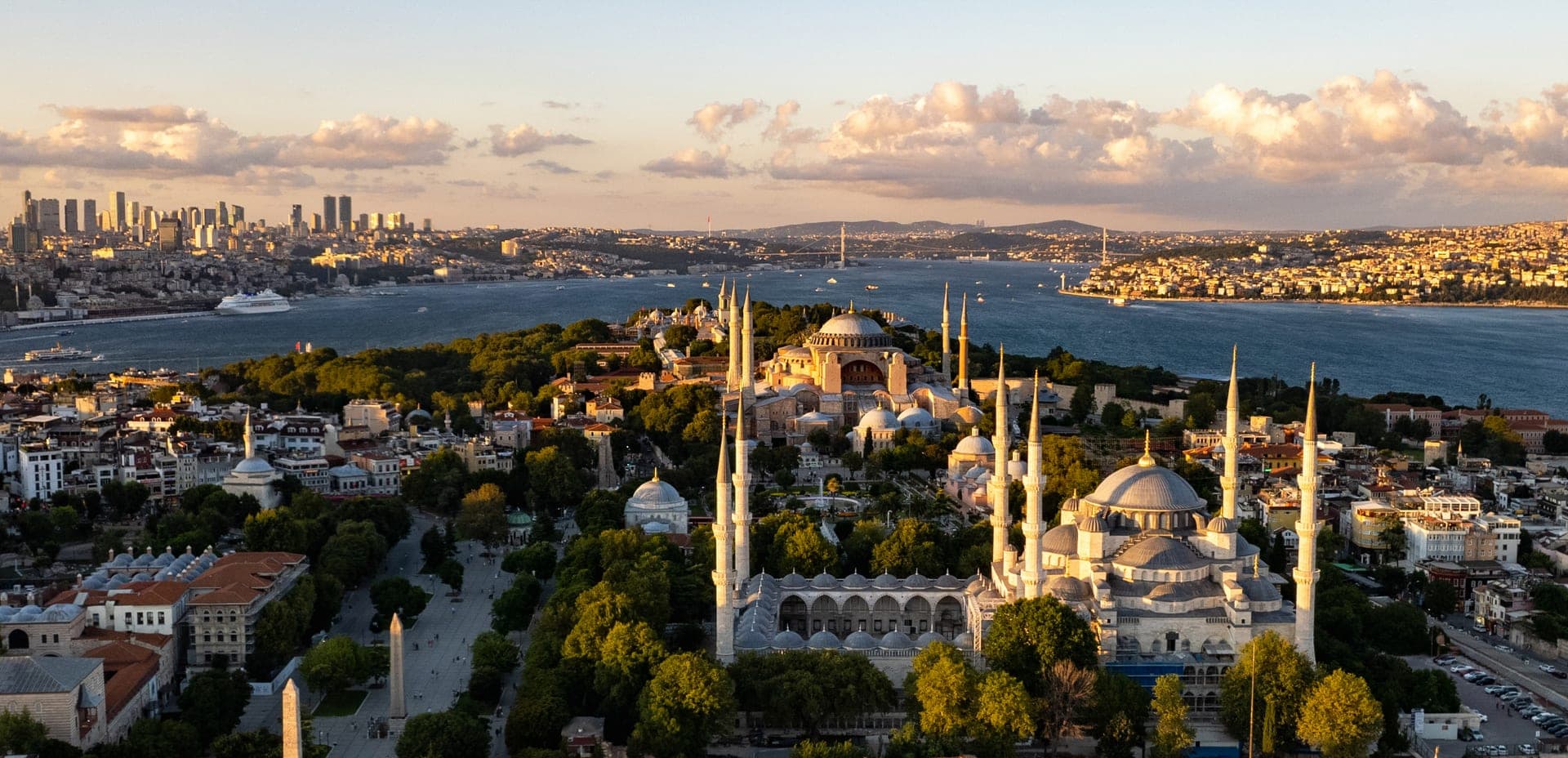 The domes and minarets of the Blue Mosque and Hagia Sophia on Istanbul's historic peninsula, with the water beyond