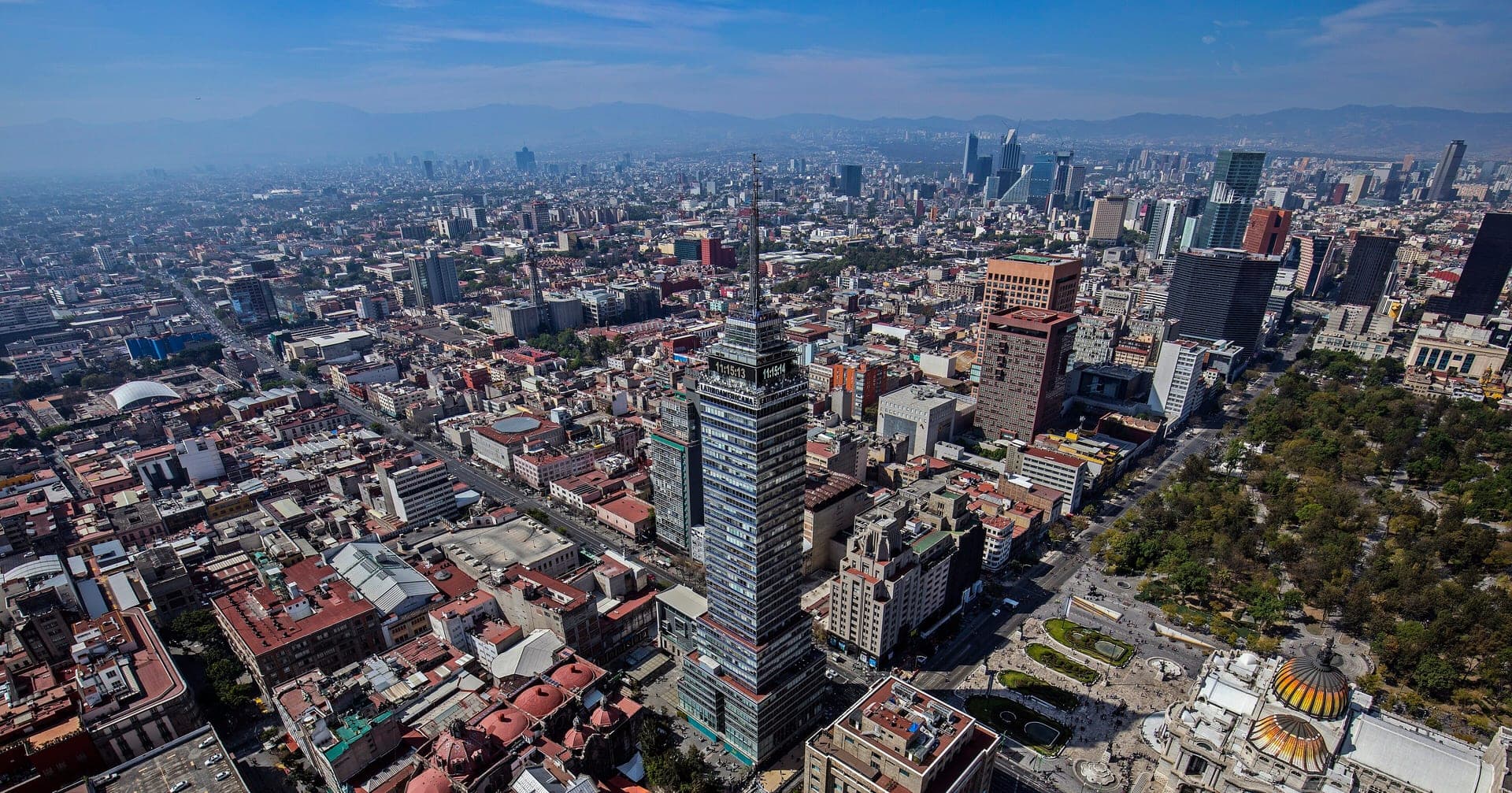 Mexico City's rooftops stretching to the horizon, the Torre Latinoamericana rising out of the middle of them